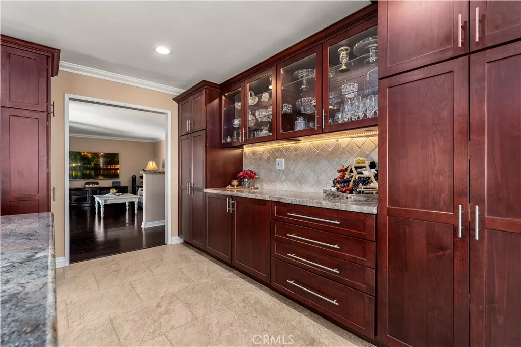 Buffet bar with kitchen rollouts, and custom cabinetry. Lots of storage space.