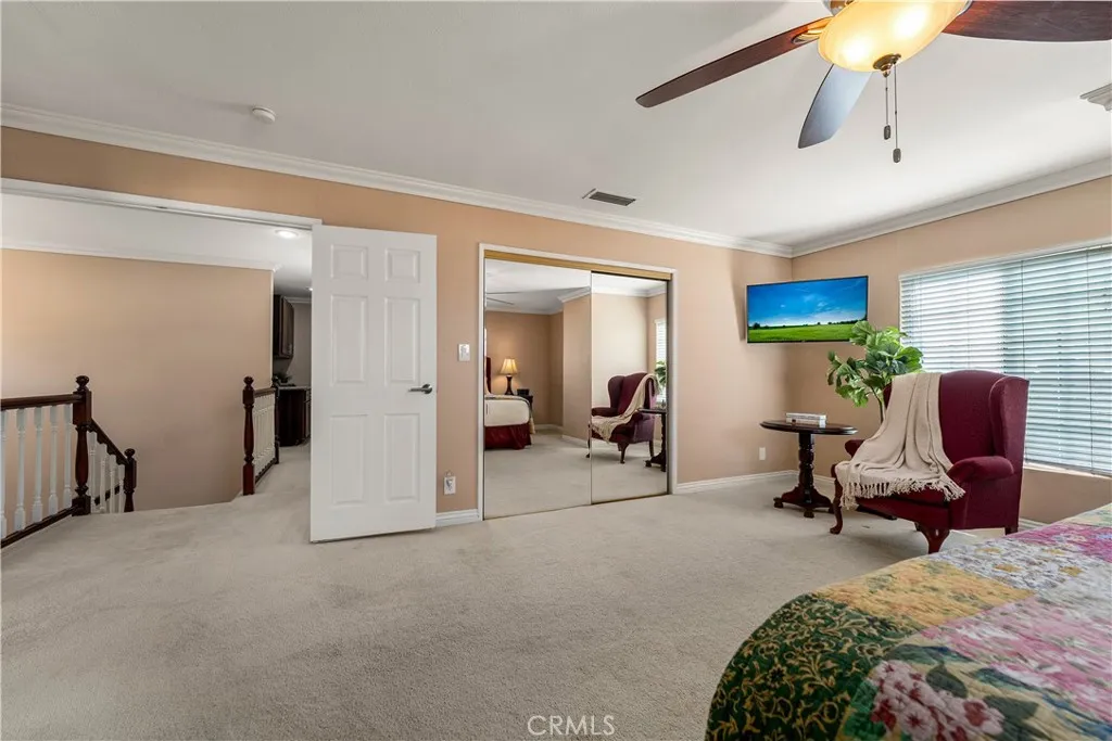 Upstairs primary bedroom with double door entry.