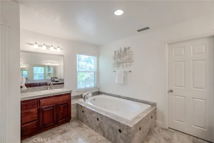 Primary Bathroom: Tub next to His Vanity