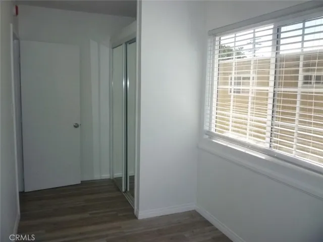 View of bedroom #2 looking toward the bedroom door and the double sliding closet doors.