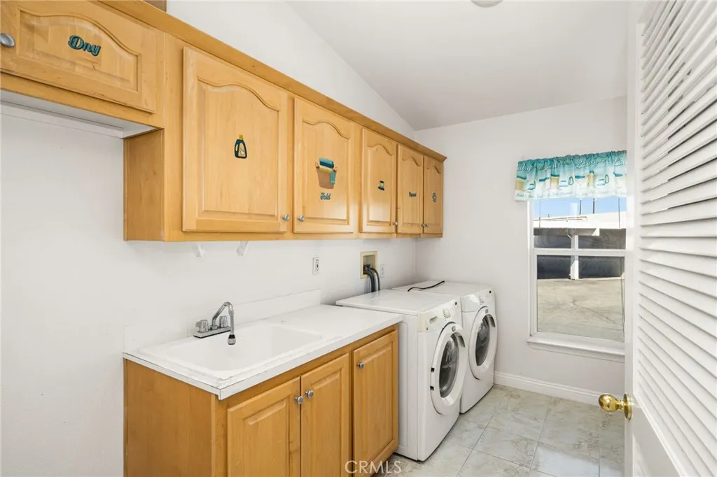 Inside Laundry Room w/ Sink & additional Storage Cabinets. Inside Laundry Room w/ Sink & additional Storage Cabinets.