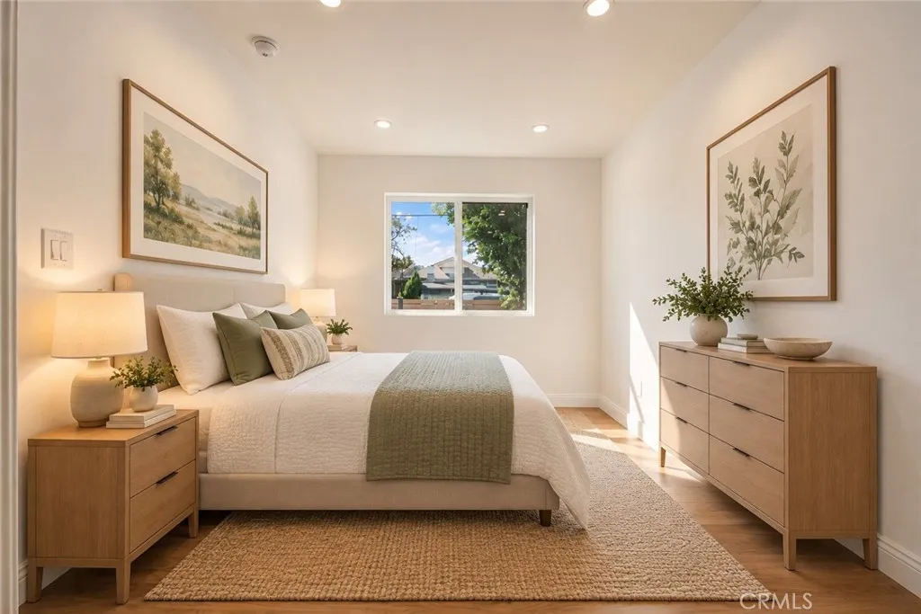 The primary suite features a walk-in closet and remodeled private bath with mosaic tile flooring, floating vanity, designer lighting, and custom-tiled tub/shower combination with glass panel. Photo is virtually staged. The primary suite features a walk-in closet and remodeled private bath with mosaic tile flooring, floating vanity, designer lighting, and custom-tiled tub/shower combination with glass panel. Photo is virtually staged.