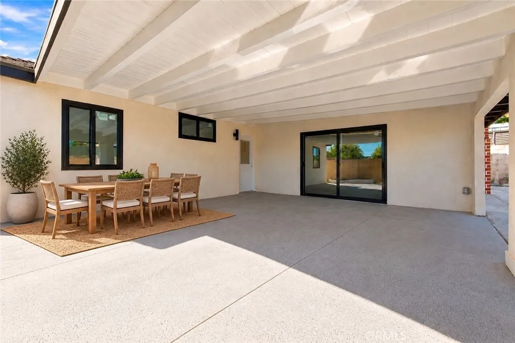 Outside, an oversized covered patio provides space for outdoor dining and gatherings while also accommodating covered parking. Two gated side-yard entrances offer additional vehicle access, and a lawn, colorful foliage, and landscaped planters enhance the backyard. A beautifully updated home with memorable architectural details and inviting spaces to enjoy inside and out! Photo is virtually staged. Outside, an oversized covered patio provides space for outdoor dining and gatherings while also accommodating covered parking. Two gated side-yard entrances offer additional vehicle access, and a lawn, colorful foliage, and landscaped planters enhance the backyard. A beautifully updated home with memorable architectural details and inviting spaces to enjoy inside and out! Photo is virtually staged.