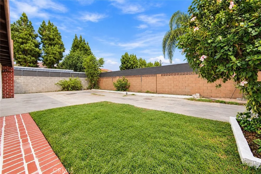 Outside, an oversized covered patio provides space for outdoor dining and gatherings while also accommodating covered parking. Two gated side-yard entrances offer additional vehicle access, and a lawn, colorful foliage, and landscaped planters enhance the backyard. A beautifully updated home with memorable architectural details and inviting spaces to enjoy inside and out! Outside, an oversized covered patio provides space for outdoor dining and gatherings while also accommodating covered parking. Two gated side-yard entrances offer additional vehicle access, and a lawn, colorful foliage, and landscaped planters enhance the backyard. A beautifully updated home with memorable architectural details and inviting spaces to enjoy inside and out!