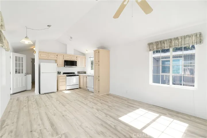 Reverse Living room view with kitchen view.