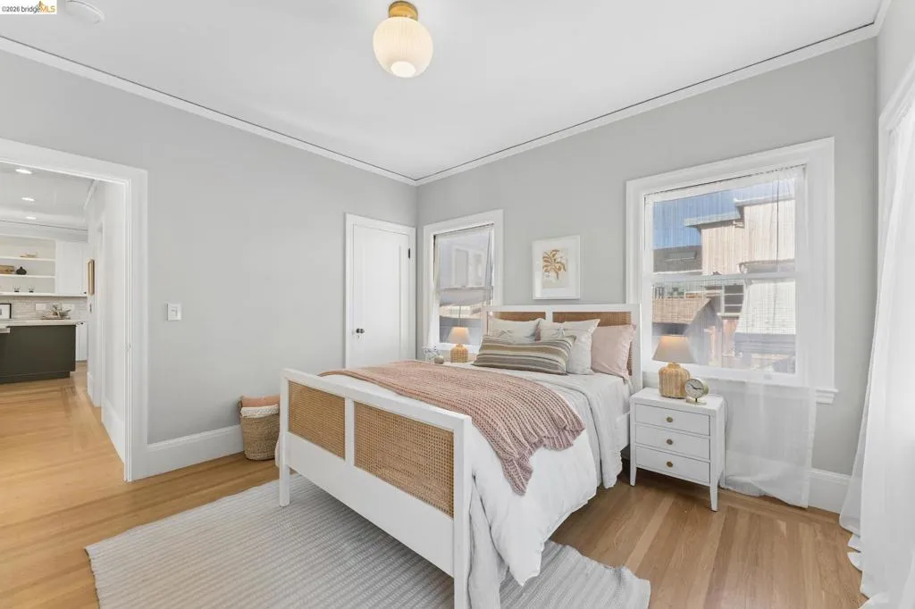 Hardwood flooring, crown molding, double-pane windows with casing, and a dome-style flush mount ceiling light fixture