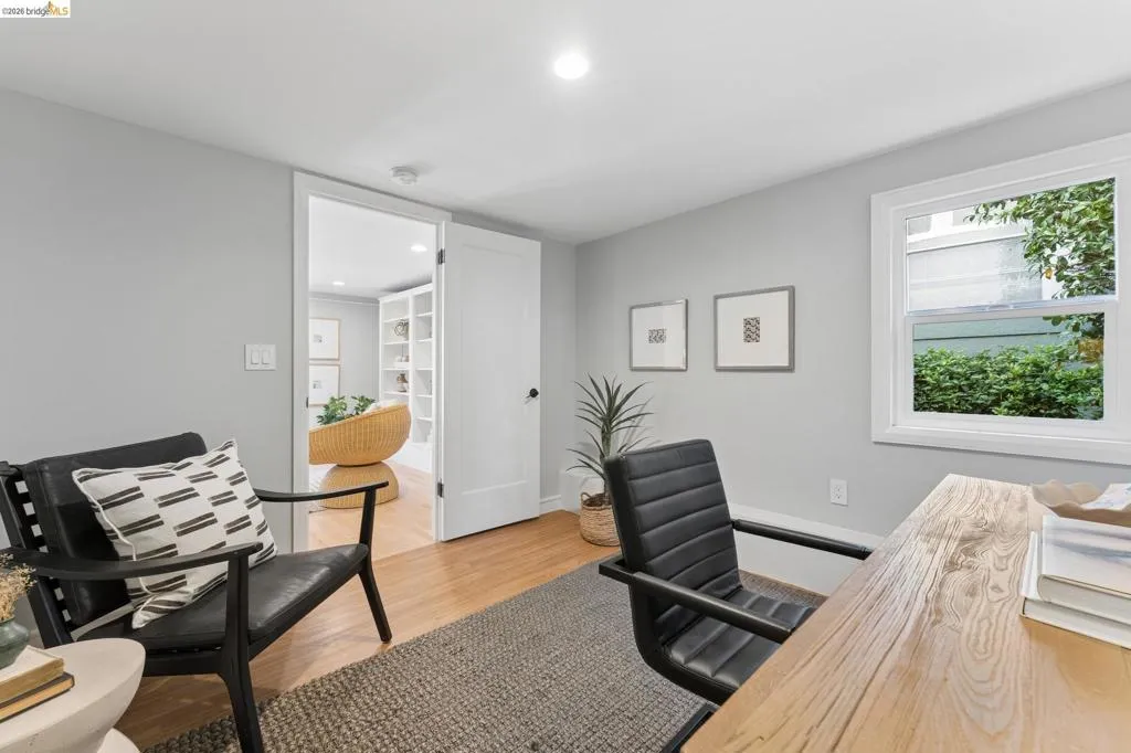 Interior space featuring wood-finish flooring, a single-hung window, recessed lighting, and a shaker-style interior door