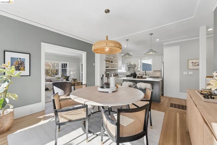 Dining area featuring wood-finish flooring, a woven pendant light, and recessed ceiling lighting