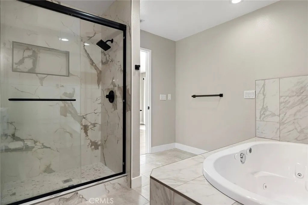 a separate glass shower and jetted soaking tub, spa-like feel a separate glass shower and jetted soaking tub, spa-like feel