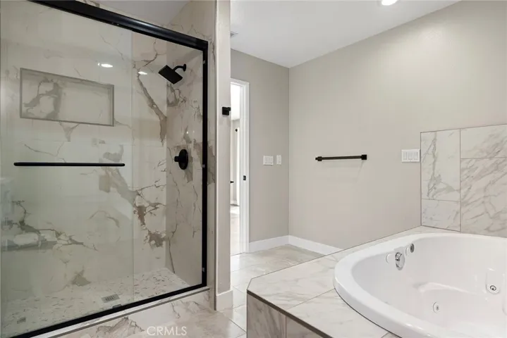 a separate glass shower and jetted soaking tub, spa-like feel