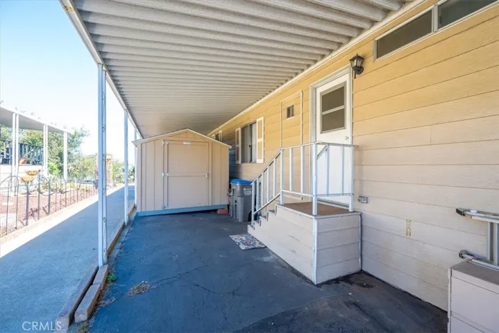 large storage shed with easy access from carport and laundry room
