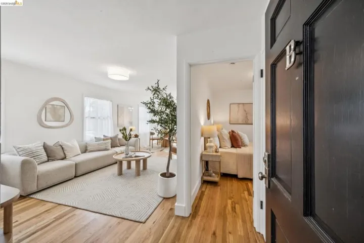 Entryway featuring a dark-toned solid door, wood-finish flooring, and recessed ceiling lighting