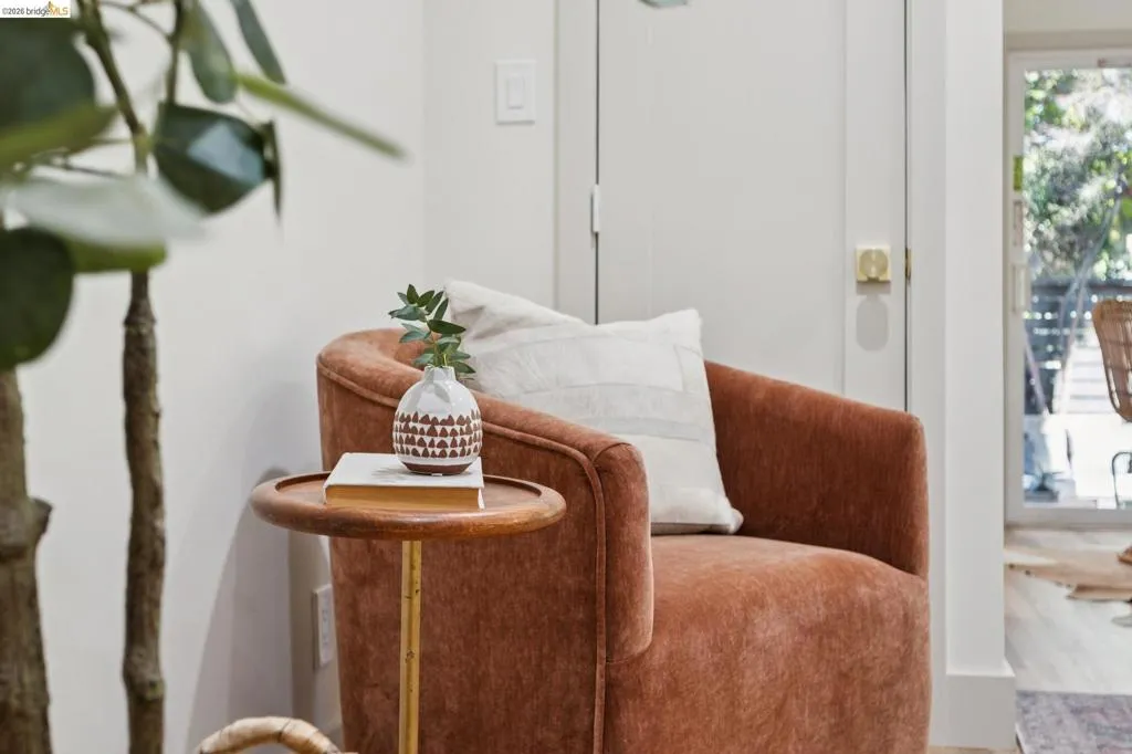 Interior space featuring neutral-toned walls, a solid core interior door with gold-tone hardware, and a glass sliding door providing outdoor visibility