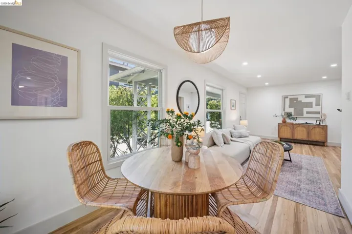 Open interior space featuring wood-finish flooring, recessed lighting, and a textured pendant fixture