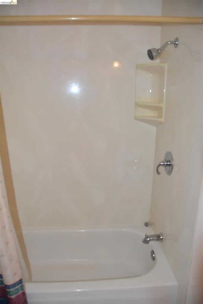 Hall bathroom with shower over tub
