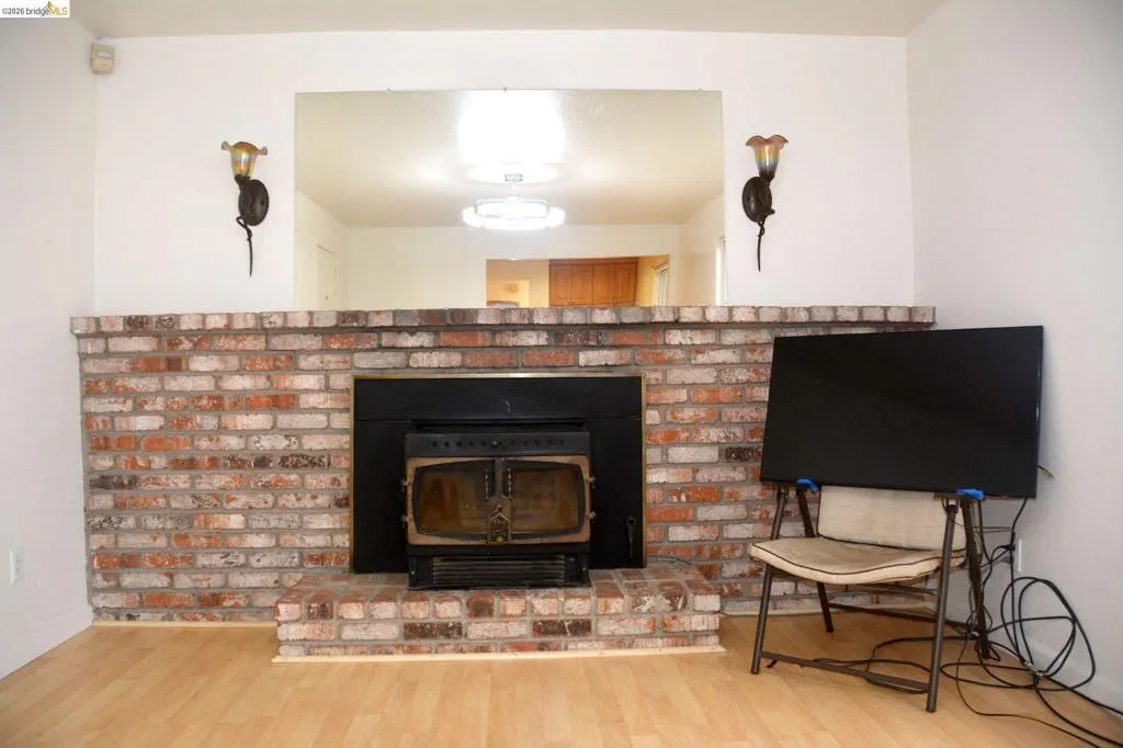 Wall to wall used brick fireplace hearth and mantle with insert