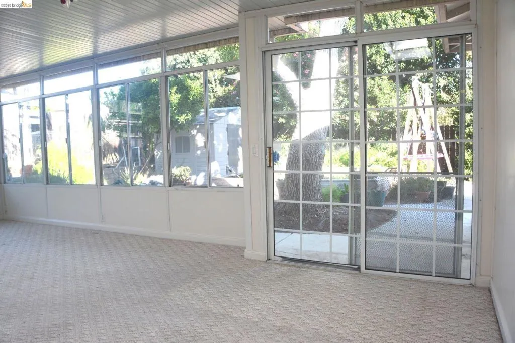 California room with two sliders to rear yard