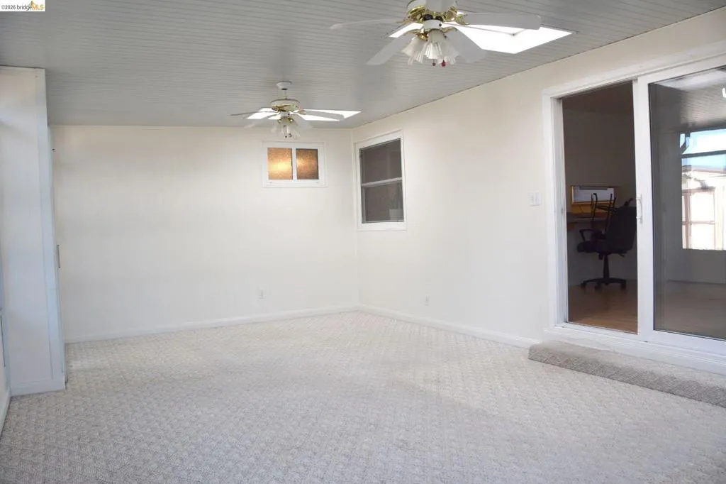California room with two skylights and two lighted ceiling fans