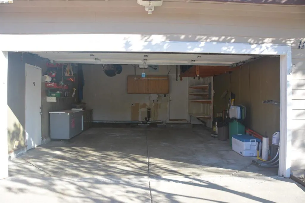 The two car garage features a metal roll-up door with opener