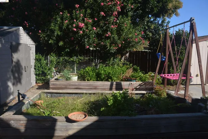 Two raised flower or vegetables beds with water spigot for each one.
