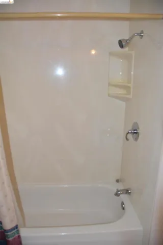Hall bathroom with shower over tub