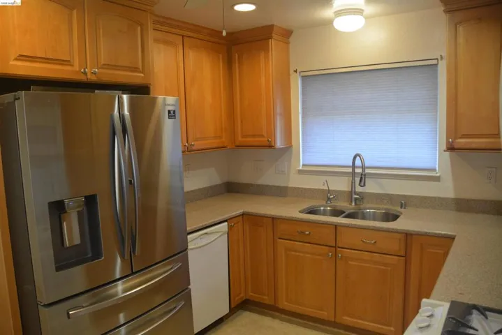 The kitchen also features: abundant cabinetry; double stainless steel sink, dishwasher and stainless steel refrigerator.
