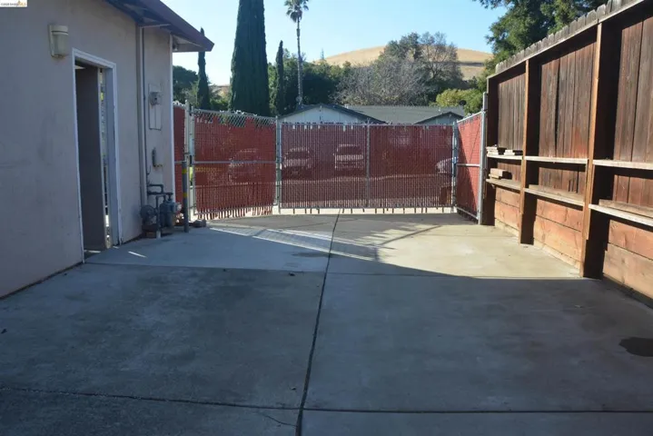 Concrete side yard RV / boat storage area with adjustable front fencing to allow for either 36 ft long x 14 ft wide or 29 ft long x 14 ft wide RV/boat storage