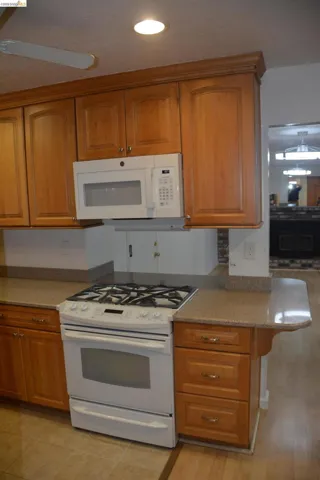 The kitchen features: a gas range/oven; microwave; and silestone counter-tops.