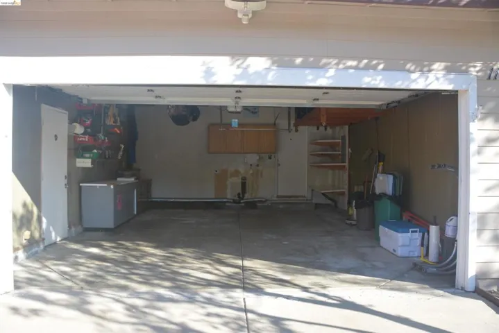 The two car garage features a metal roll-up door with opener