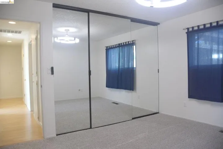 Master bedroom closet with mirrored wardrobe doors