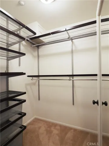 Walk in closet in the primary bedroom
