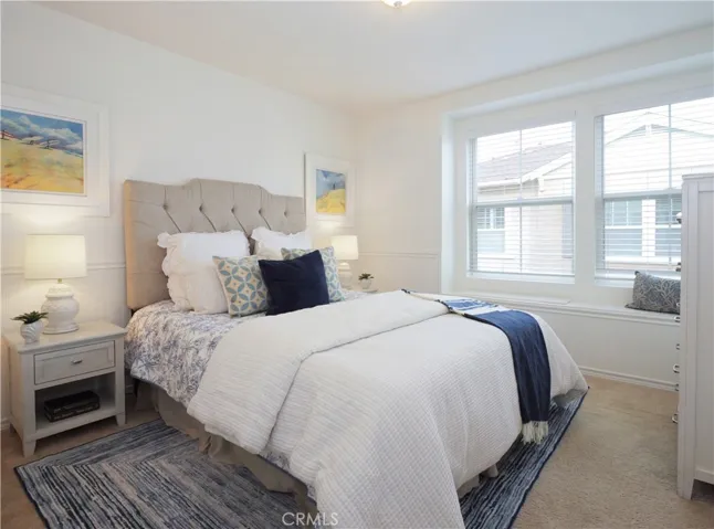 Second bedroom has elegant wainscoting panel walls