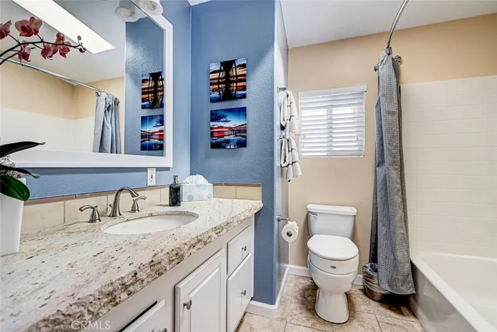 Striking oversized bath with chiseled stone vanity.