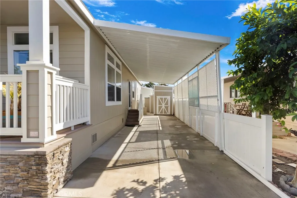 View of carport and shed beyond.