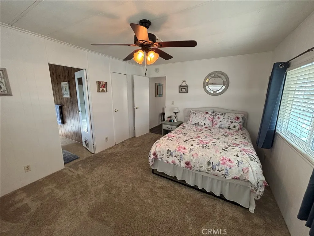 Newer carpet and ceiling fan in Primary