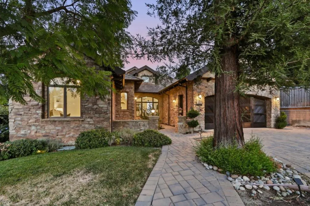 Front of home at twilight with stone facade and glowing windows, Los Gatos Front of home at twilight with stone facade and glowing windows, Los Gatos