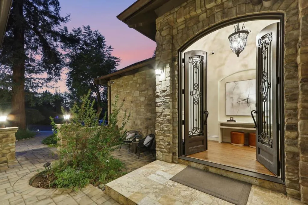Arched iron entry doors and stone entry at twilight, Los Gatos Arched iron entry doors and stone entry at twilight, Los Gatos