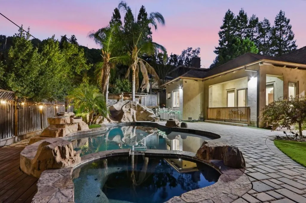 Pool waterfall and palms with the home at dusk, Los Gatos Pool waterfall and palms with the home at dusk, Los Gatos