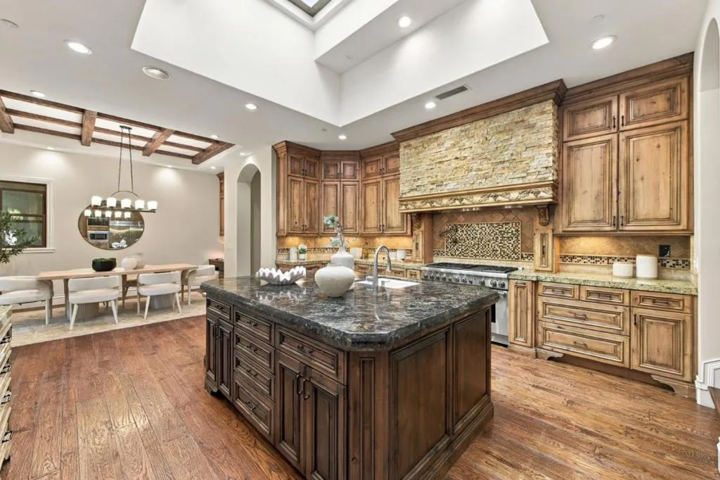 Kitchen island with dark granite counters, wood hood and skylights, Los Gatos Kitchen island with dark granite counters, wood hood and skylights, Los Gatos