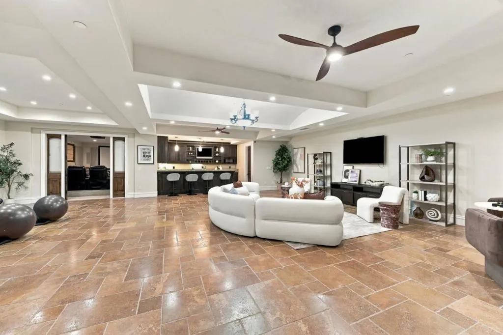 Basement great room with stone floors and curved white sectional, Los Gatos Basement great room with stone floors and curved white sectional, Los Gatos