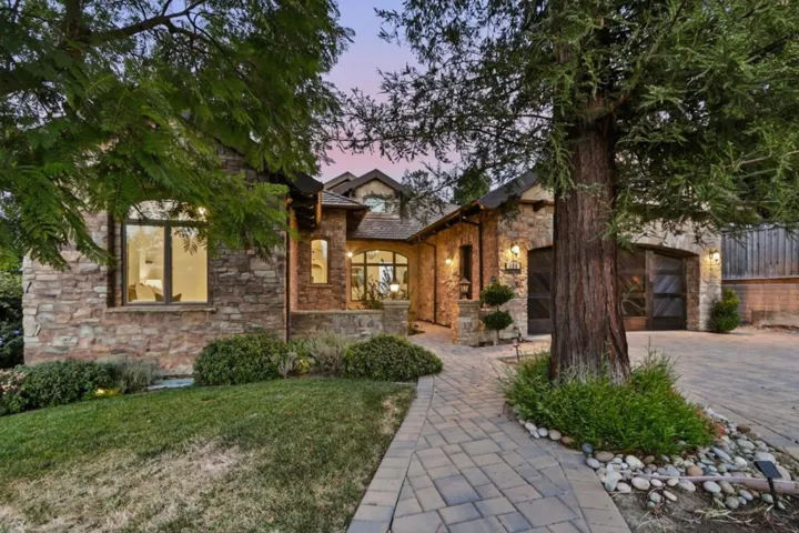 Front of home at twilight with stone facade and glowing windows, Los Gatos
