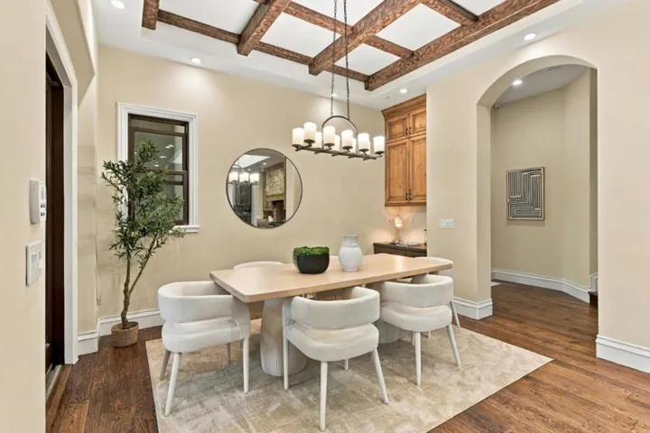 Formal dining room with round mirror, chandelier and arched entry, Los Gatos