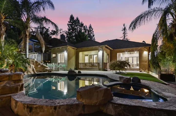 Spa and pool with rear of the home at dusk, Los Gatos