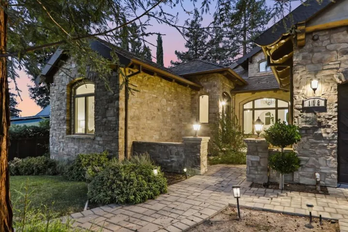 Stone entry and front windows at twilight, Los Gatos