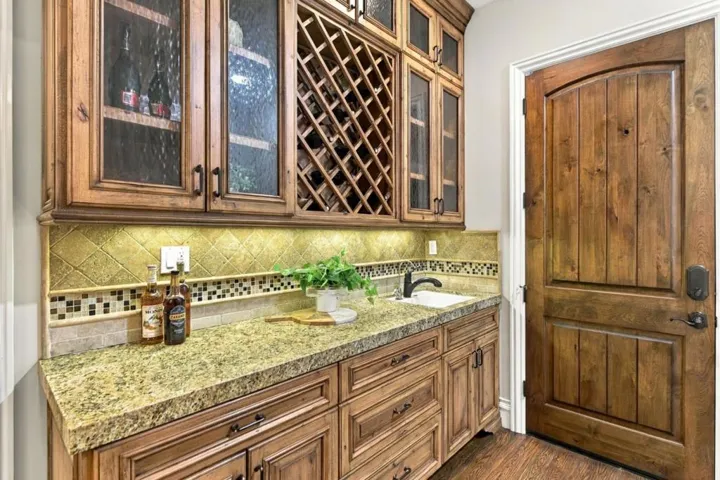Basement wet bar with granite counter, wine rack and glass cabinets, Los Gatos