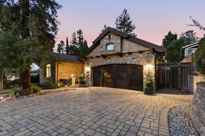 Garage doors and paver motor court at dusk, Los Gatos