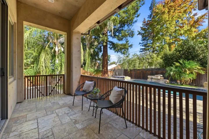 Covered deck with wood railing overlooking the backyard, Los Gatos