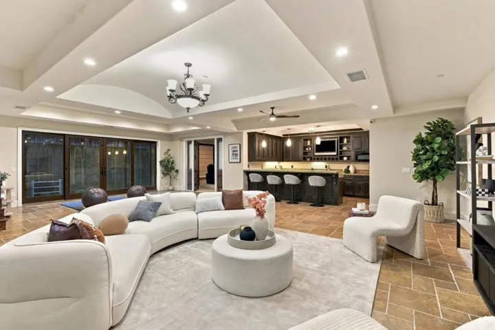 Basement great room with curved sectional, chandelier and bar, Los Gatos