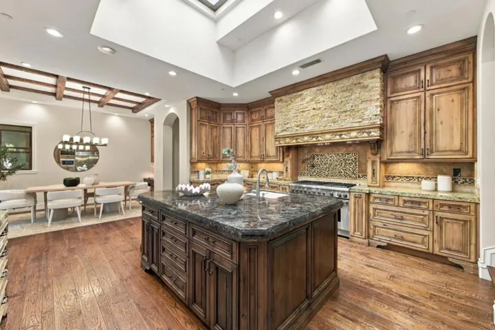 Kitchen island with dark granite counters, wood hood and skylights, Los Gatos