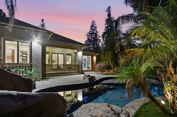 Pool, spa and covered porch at dusk, Los Gatos